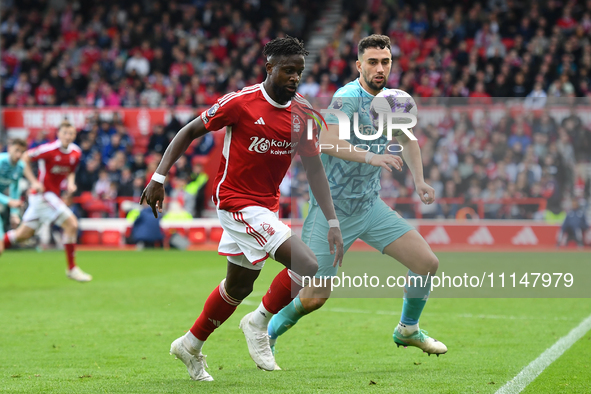 Divock Origi of Nottingham Forest is under pressure from Max Kilman of Wolverhampton Wanderers during the Premier League match between Notti...