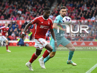 Divock Origi of Nottingham Forest is under pressure from Max Kilman of Wolverhampton Wanderers during the Premier League match between Notti...