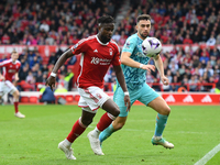 Divock Origi of Nottingham Forest is under pressure from Max Kilman of Wolverhampton Wanderers during the Premier League match between Notti...