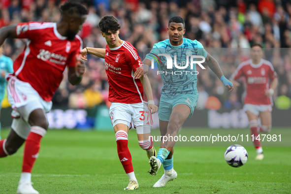 Rodrigo Ribeiro of Nottingham Forest is under pressure from Mario Lemina of Wolverhampton Wanderers during the Premier League match between...