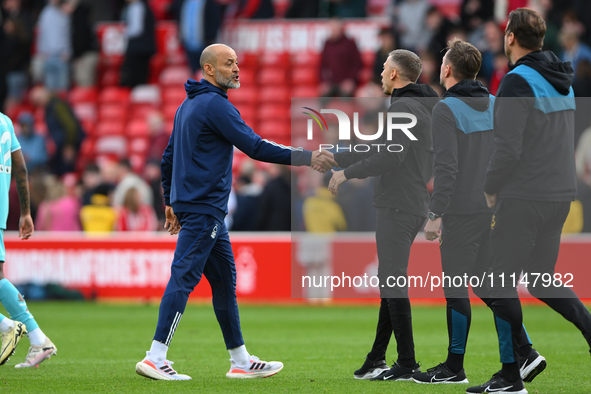 Nuno Espirito Santo, the head coach of Nottingham Forest, is shaking hands with Gary O'Neil, the manager of Wolverhampton Wanderers, during...