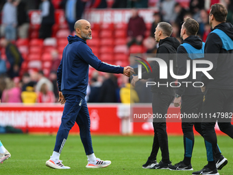 Nuno Espirito Santo, the head coach of Nottingham Forest, is shaking hands with Gary O'Neil, the manager of Wolverhampton Wanderers, during...