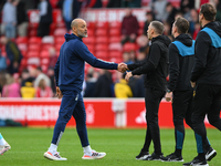 Nuno Espirito Santo, the head coach of Nottingham Forest, is shaking hands with Gary O'Neil, the manager of Wolverhampton Wanderers, during...