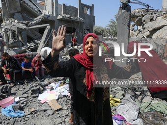 Palestinians are inspecting the damage to a building following Israeli bombardment in the Maghazi camp for Palestinian refugees in the centr...