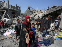 Palestinians are inspecting the damage to a building following Israeli bombardment in the Maghazi camp for Palestinian refugees in the centr...