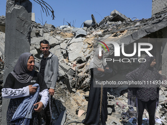 Palestinians are inspecting the damage to a building following Israeli bombardment in the Maghazi camp for Palestinian refugees in the centr...