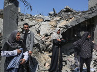 Palestinians are inspecting the damage to a building following Israeli bombardment in the Maghazi camp for Palestinian refugees in the centr...