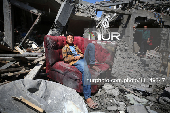 Palestinians are inspecting the damage to a building following Israeli bombardment in the Maghazi camp for Palestinian refugees in the centr...