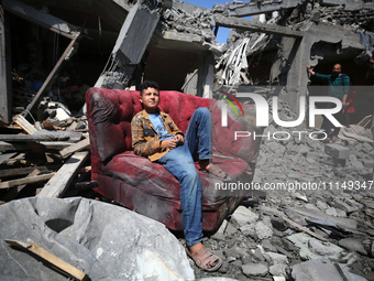 Palestinians are inspecting the damage to a building following Israeli bombardment in the Maghazi camp for Palestinian refugees in the centr...