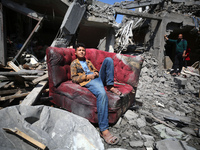 Palestinians are inspecting the damage to a building following Israeli bombardment in the Maghazi camp for Palestinian refugees in the centr...