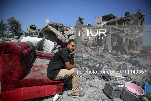 Palestinians are inspecting the damage to a building following Israeli bombardment in the Maghazi camp for Palestinian refugees in the centr...