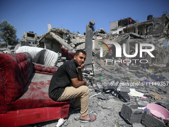 Palestinians are inspecting the damage to a building following Israeli bombardment in the Maghazi camp for Palestinian refugees in the centr...