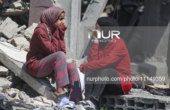 Palestinians are inspecting the damage to a building following Israeli bombardment in the Maghazi camp for Palestinian refugees in the centr...