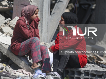 Palestinians are inspecting the damage to a building following Israeli bombardment in the Maghazi camp for Palestinian refugees in the centr...