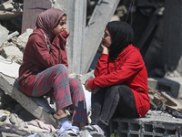 Palestinians are inspecting the damage to a building following Israeli bombardment in the Maghazi camp for Palestinian refugees in the centr...