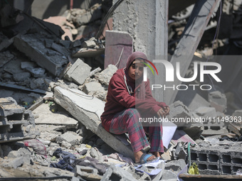 Palestinians are inspecting the damage to a building following Israeli bombardment in the Maghazi camp for Palestinian refugees in the centr...