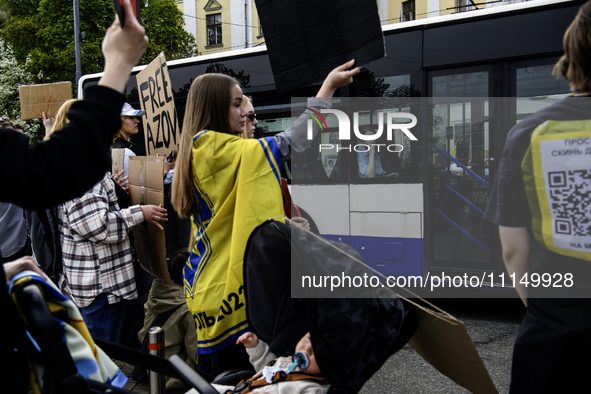 Passengers on public transport are passing by the action ''Don't be silent. Captivity Kills'' in support of the captured Azovstal defenders,...