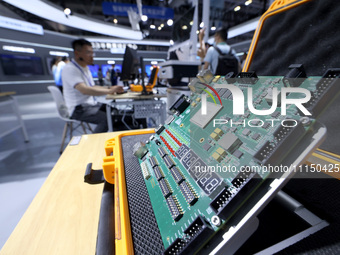 A staff member is demonstrating a computer experiment at the 61st China Higher Education Expo in Fuzhou, Fujian Province, China, on April 15...