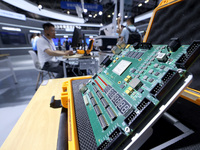 A staff member is demonstrating a computer experiment at the 61st China Higher Education Expo in Fuzhou, Fujian Province, China, on April 15...