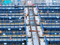 Construction workers are working at the construction site of the Zhangjinggao Yangtze River Bridge in Rugao, Jiangsu Province, China, on Apr...