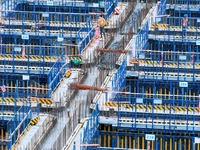 Construction workers are working at the construction site of the Zhangjinggao Yangtze River Bridge in Rugao, Jiangsu Province, China, on Apr...