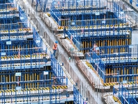 Construction workers are working at the construction site of the Zhangjinggao Yangtze River Bridge in Rugao, Jiangsu Province, China, on Apr...