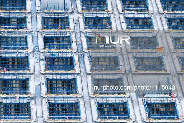 Construction workers are working at the construction site of the Zhangjinggao Yangtze River Bridge in Rugao, Jiangsu Province, China, on Apr...