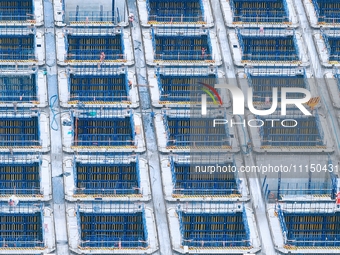 Construction workers are working at the construction site of the Zhangjinggao Yangtze River Bridge in Rugao, Jiangsu Province, China, on Apr...