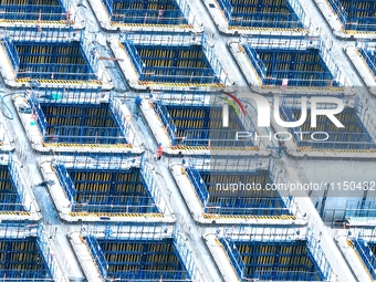 Construction workers are working at the construction site of the Zhangjinggao Yangtze River Bridge in Rugao, Jiangsu Province, China, on Apr...