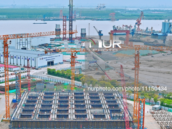 Construction workers are working at the construction site of the Zhangjinggao Yangtze River Bridge in Rugao, Jiangsu Province, China, on Apr...