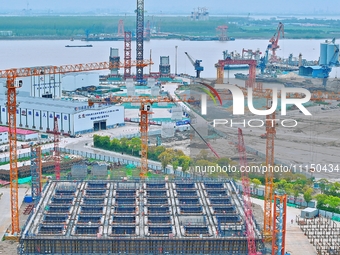 Construction workers are working at the construction site of the Zhangjinggao Yangtze River Bridge in Rugao, Jiangsu Province, China, on Apr...