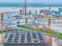 Construction workers are working at the construction site of the Zhangjinggao Yangtze River Bridge in Rugao, Jiangsu Province, China, on Apr...