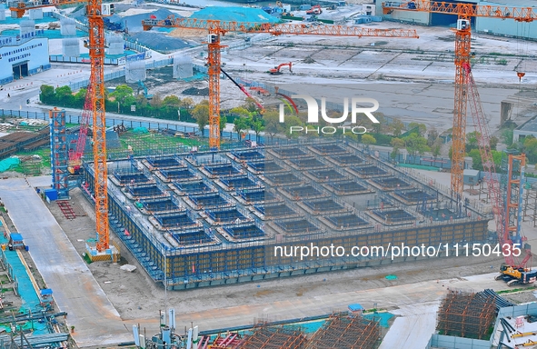 Construction workers are working at the construction site of the Zhangjinggao Yangtze River Bridge in Rugao, Jiangsu Province, China, on Apr...