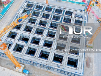 Construction workers are working at the construction site of the Zhangjinggao Yangtze River Bridge in Rugao, Jiangsu Province, China, on Apr...