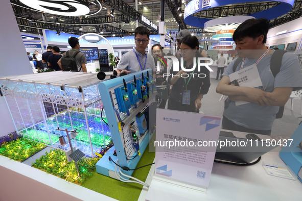 People are visiting a training platform for smart agriculture at the 61st China Higher Education Expo in Fuzhou, Fujian Province, China, on...