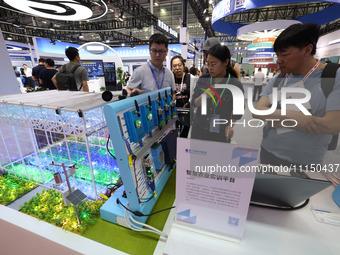 People are visiting a training platform for smart agriculture at the 61st China Higher Education Expo in Fuzhou, Fujian Province, China, on...