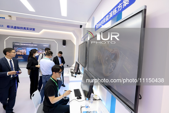 Citizens are experiencing VR projects at the exhibition area of the 61st China Higher Education Expo in Fuzhou, Fujian province, China, on A...