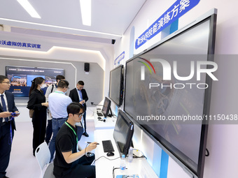 Citizens are experiencing VR projects at the exhibition area of the 61st China Higher Education Expo in Fuzhou, Fujian province, China, on A...