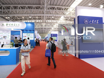 Citizens are visiting the exhibition area of the 61st China Higher Education Expo in Fuzhou, Fujian Province, China, on April 15, 2024. (