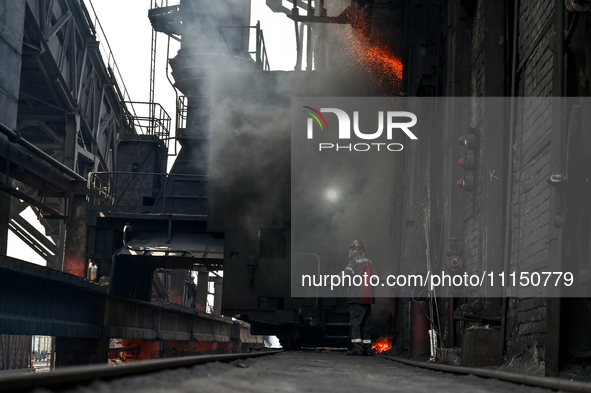 A worker is seen on the premises of PJSC Zaporizhcoke in Zaporizhzhia, Ukraine, on April 11, 2024. NO USE RUSSIA. NO USE BELARUS. 