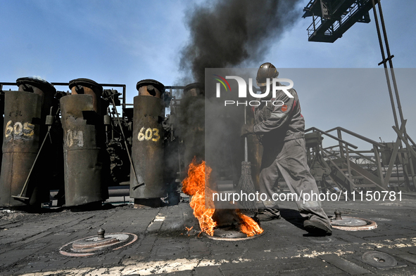 A worker is sweeping on the premises of PJSC Zaporizhcoke in Zaporizhzhia, southeastern Ukraine, on April 11, 2024. NO USE RUSSIA. NO USE BE...