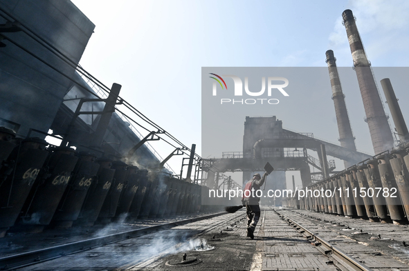 A worker is sweeping on the premises of PJSC Zaporizhcoke in Zaporizhzhia, southeastern Ukraine, on April 11, 2024. NO USE RUSSIA. NO USE BE...