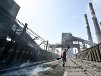 A worker is sweeping on the premises of PJSC Zaporizhcoke in Zaporizhzhia, southeastern Ukraine, on April 11, 2024. NO USE RUSSIA. NO USE BE...