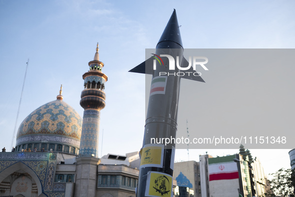 A model of Iran's first-ever hypersonic missile, Fattah, is being displayed next to a mosque while hundreds of Iranians are celebrating the...