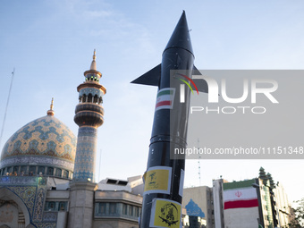 A model of Iran's first-ever hypersonic missile, Fattah, is being displayed next to a mosque while hundreds of Iranians are celebrating the...