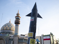 A model of Iran's first-ever hypersonic missile, Fattah, is being displayed next to a mosque while hundreds of Iranians are celebrating the...