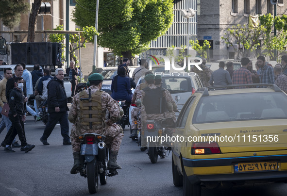 Members of the Islamic Revolutionary Guard Corps (IRGC) Special Forces are riding motorcycles during a celebration of the IRGC's unmanned ae...