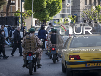 Members of the Islamic Revolutionary Guard Corps (IRGC) Special Forces are riding motorcycles during a celebration of the IRGC's unmanned ae...