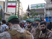 Members of the Islamic Revolutionary Guard Corps (IRGC) Special Forces are standing together under a model of Iran's first-ever hypersonic m...