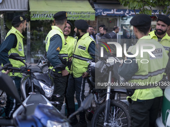 Iranian police special forces are standing together during a gathering to celebrate the IRGC's unmanned aerial vehicle (UAV) and missile att...